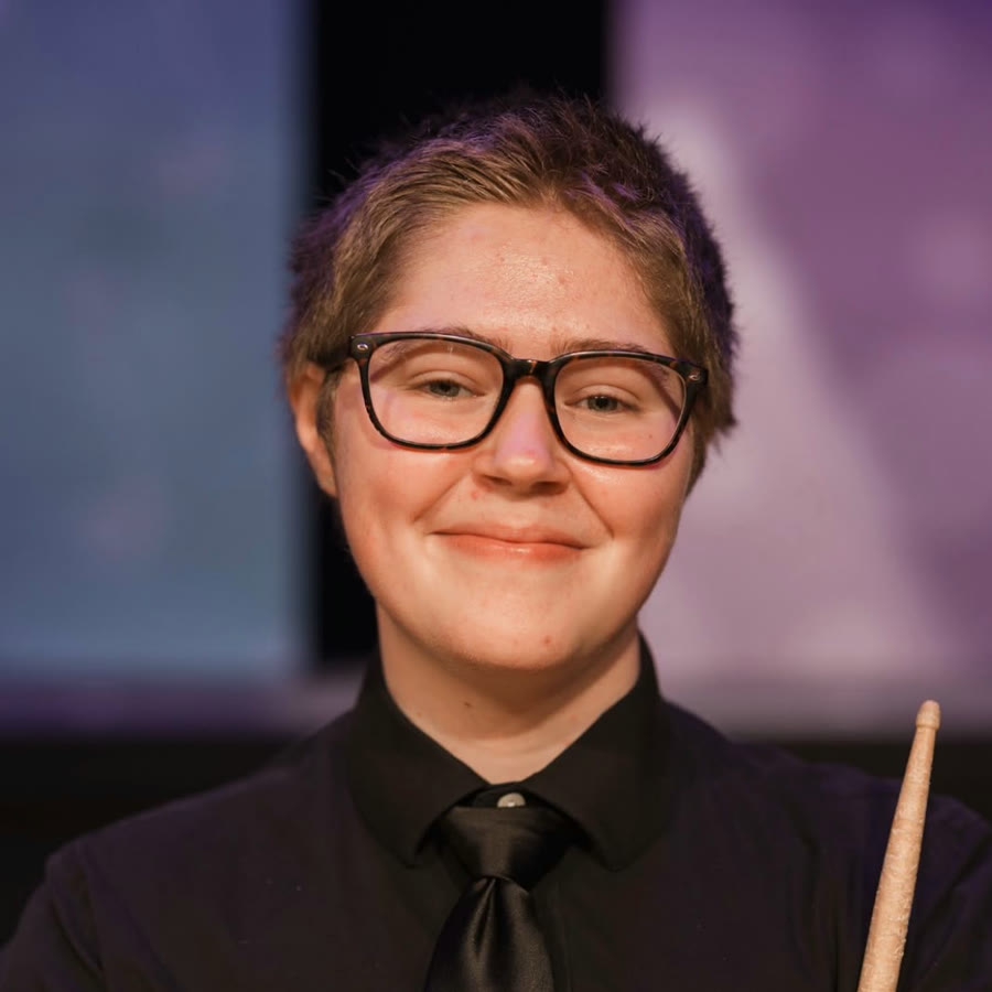 Courtney Craig holding a pair of pan sticks
