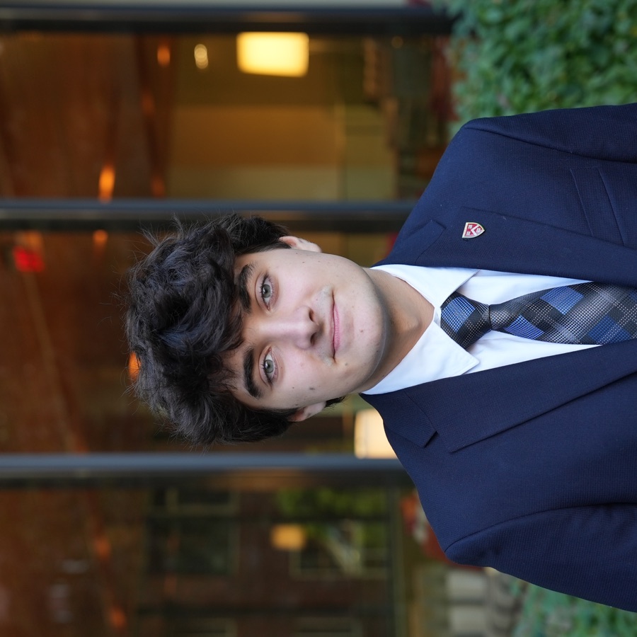 TJ Dolan wearing a suit and tie