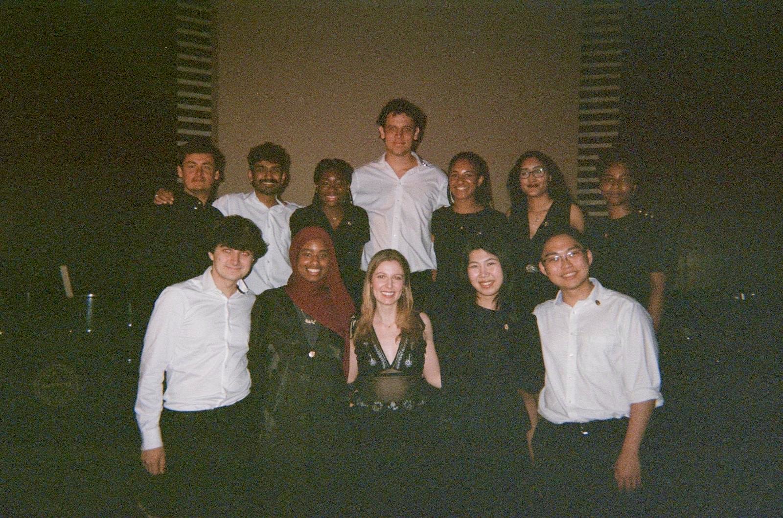 The full ensemble in black and white concert dress after their performance in Trinidad.
