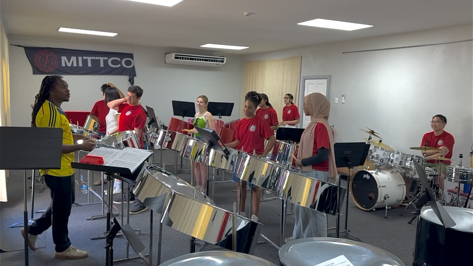 Charlton Alfonso leading the ensemble in a rehearsal at MITTCO.